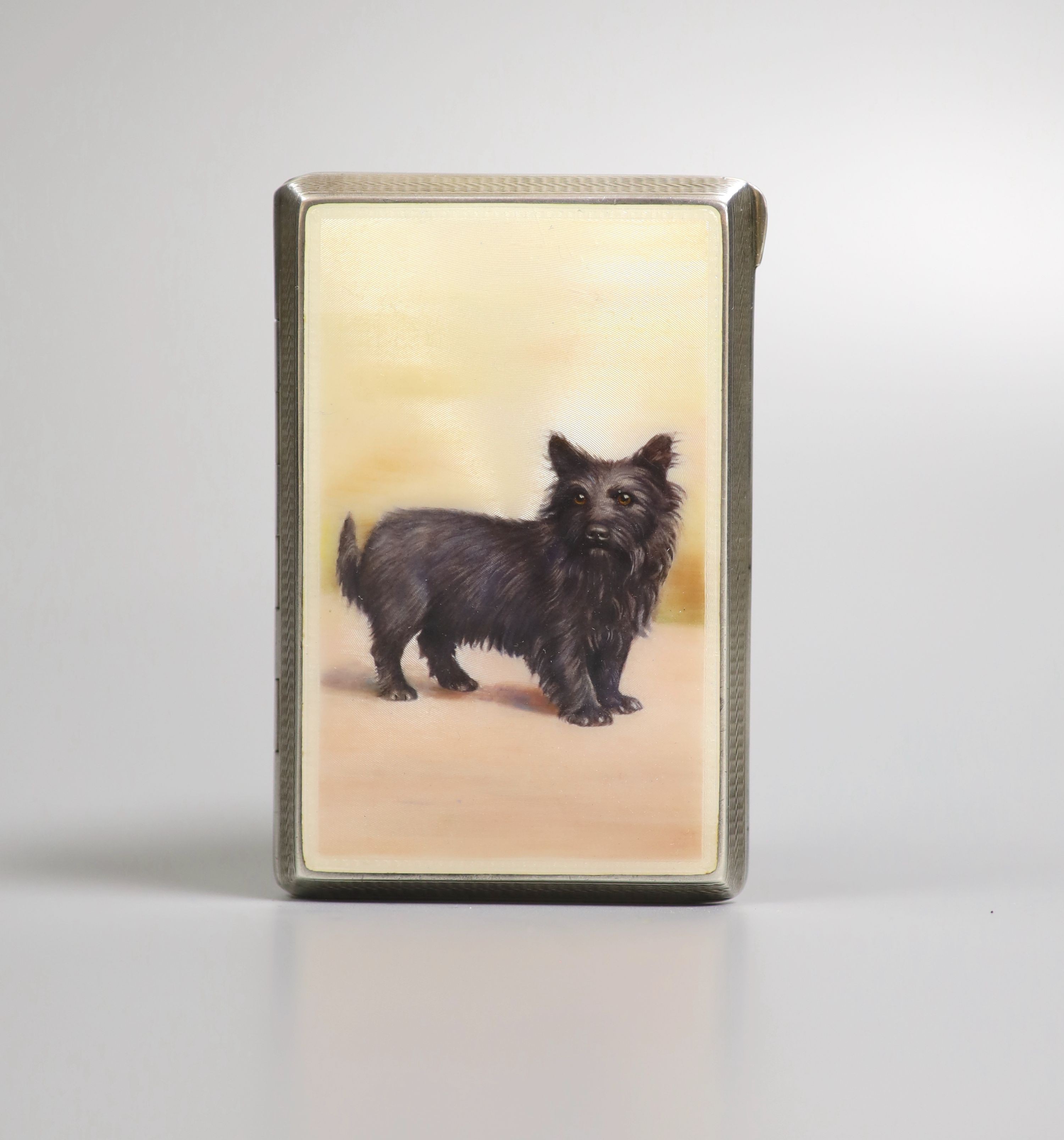 A George V silver and enamel cigarette case, the enamel decorated with a dog, import marks for London, 1928, 87mm.